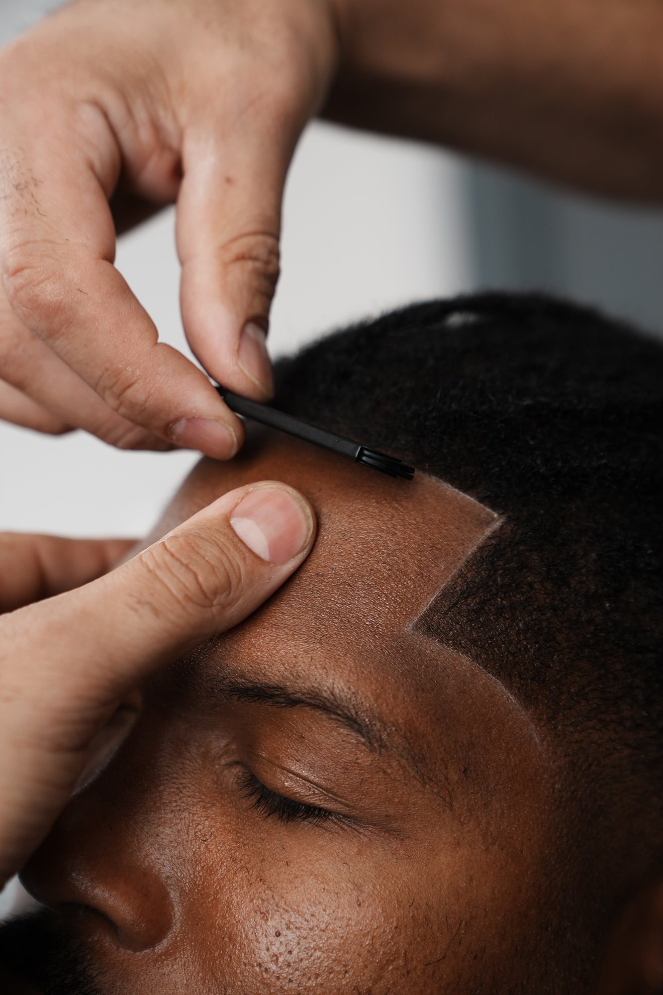 Person getting a haircut with a comb and scissors