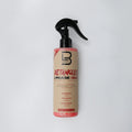 Detangler spray bottle with black nozzle on a white background