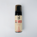 Texturizing wave mousse bottle with brand logo on a light gray background