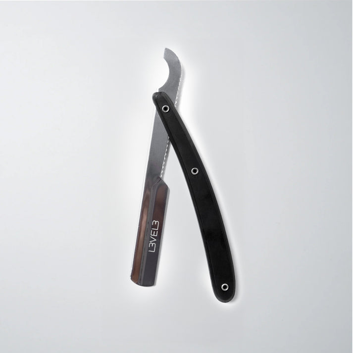 a straight razor with a black handle